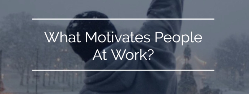Image of a back of a person punching the air with an overlay of What Motivates People At Work
