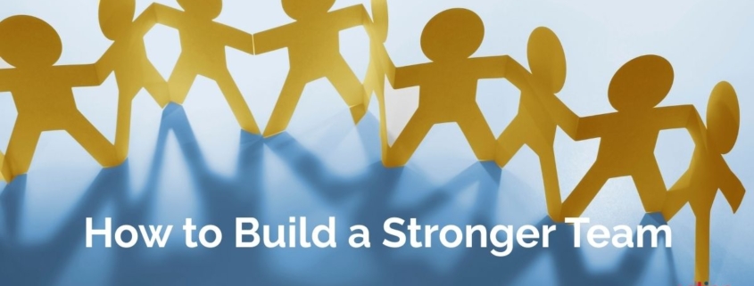 Paper cut-out chain of people holding hands, representing teamwork, collaboration, and strategies for building a stronger business team.