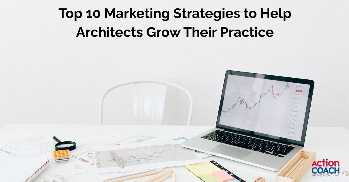 Open laptop showing a rising graph with scattered marketing notes and stationery on desk — symbolizing top marketing strategies for architects to grow their practice.